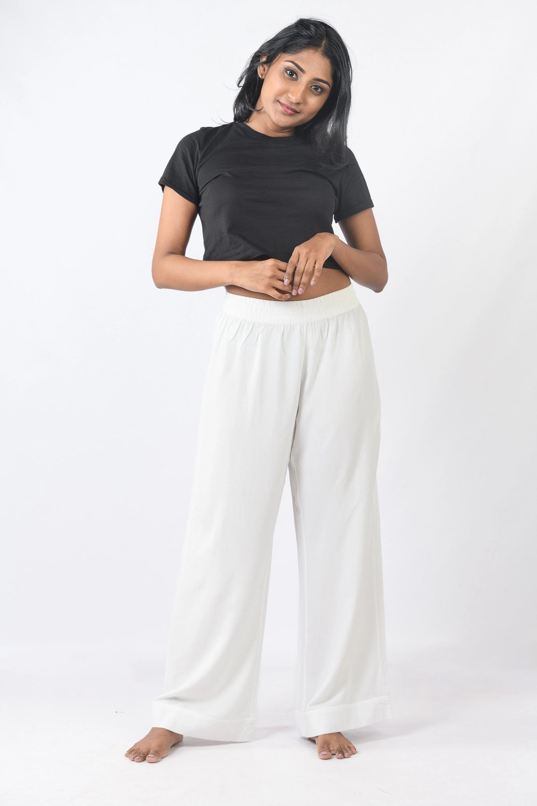 White high-waisted wide-leg pants. Trendy and comfortable all year round in Sri Lanka for a chic look.