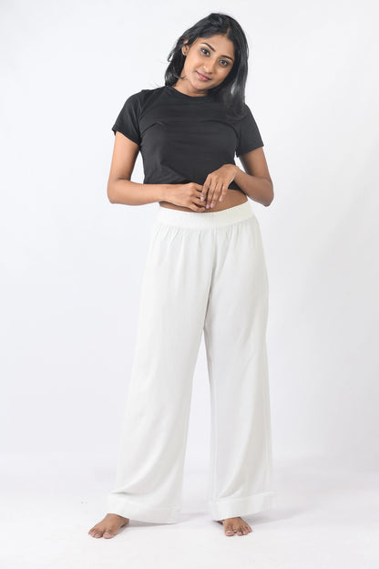 White high-waisted wide-leg pants. Trendy and comfortable all year round in Sri Lanka for a chic look.